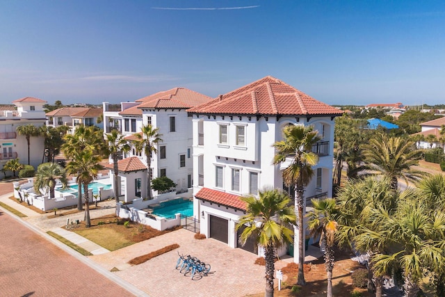 4782 Ocean Blvd, Destin, FL 32541 - view of front facade featuring a tiled roof, decorative driveway, a garage, and stucco siding