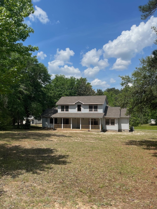 5882 Willow Ln, Crestview, FL 32539 - view of front facade with covered porch, a front yard, and a shingled roof