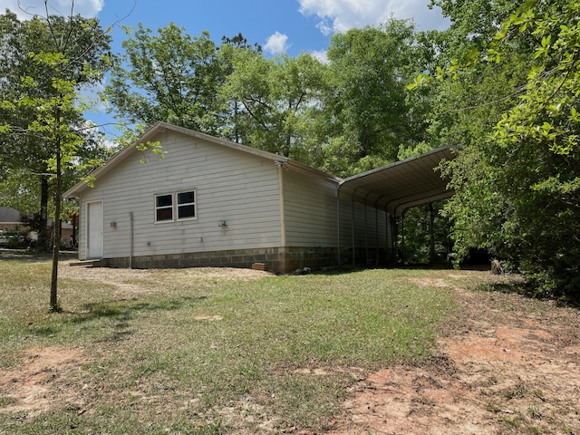 5882 Willow Ln, Crestview, FL 32539 - view of property exterior with a yard, a detached carport, and dirt driveway