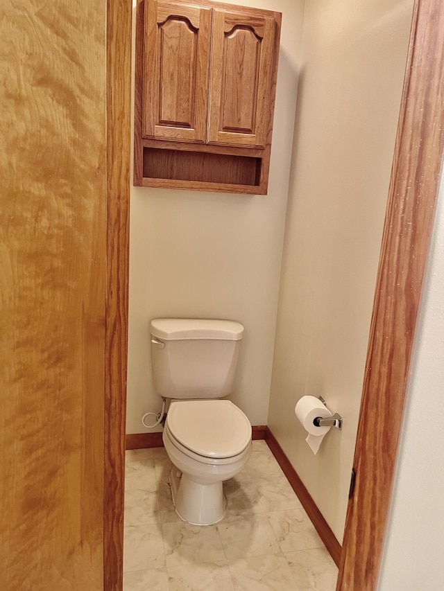 5882 Willow Ln, Crestview, FL 32539 - bathroom featuring marble finish floors, toilet, and baseboards