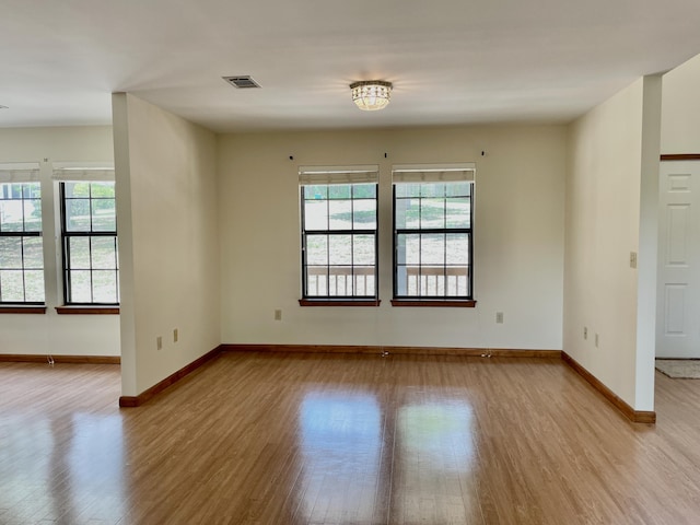 5882 Willow Ln, Crestview, FL 32539 - empty room with wood finished floors, plenty of natural light, and baseboards