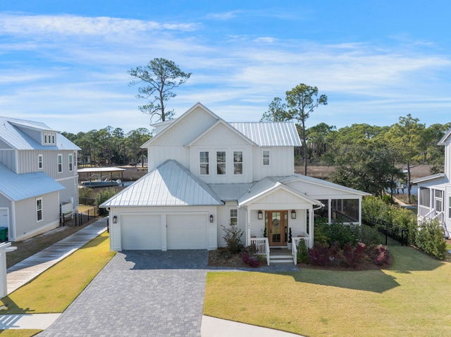 180 Bayou Edge Lndg, Santa Rosa Beach, FL 32459 - modern farmhouse with decorative driveway, a front lawn, a porch, and metal roof