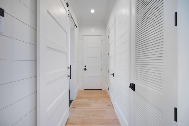 180 Bayou Edge Lndg, Santa Rosa Beach, FL 32459 - hallway with a barn door, light wood finished floors, recessed lighting, and ornamental molding