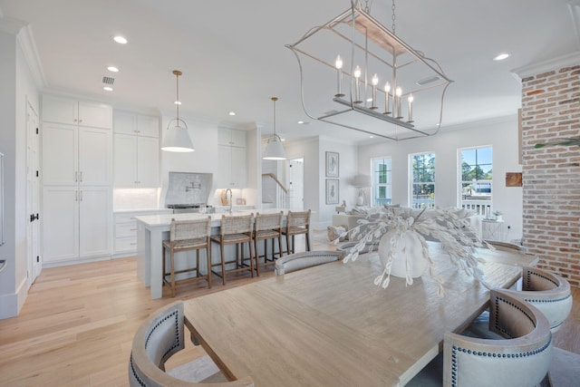180 Bayou Edge Lndg, Santa Rosa Beach, FL 32459 - dining space with light wood-style floors, recessed lighting, and ornamental molding