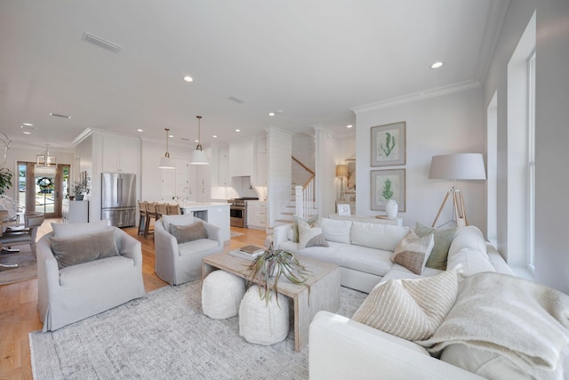 180 Bayou Edge Lndg, Santa Rosa Beach, FL 32459 - living area with stairway, ornamental molding, light wood-style floors, and recessed lighting
