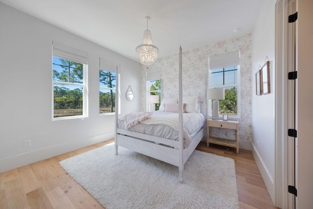 180 Bayou Edge Lndg, Santa Rosa Beach, FL 32459 - bedroom with multiple windows, a chandelier, and baseboards