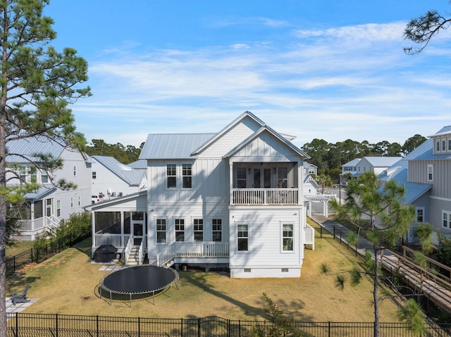 180 Bayou Edge Lndg, Santa Rosa Beach, FL 32459 - rear view of property featuring a sunroom, a trampoline, board and batten siding, crawl space, and a deck