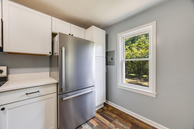 kitchen with freestanding refrigerator, baseboards, dark wood-style flooring, light countertops, and white cabinetry