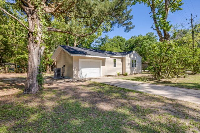 view of home's exterior featuring driveway, an attached garage, and cooling unit