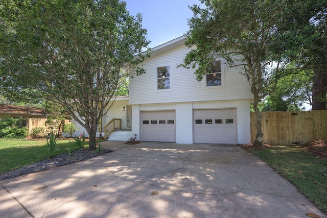 20 NW Higdon Ct, Fort Walton Beach, FL 32547 - view of front facade with a garage, brick siding, and concrete driveway