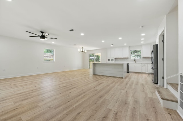 20 NW Higdon Ct, Fort Walton Beach, FL 32547 - unfurnished living room featuring recessed lighting, plenty of natural light, light wood-style flooring, a chandelier, and ceiling fan