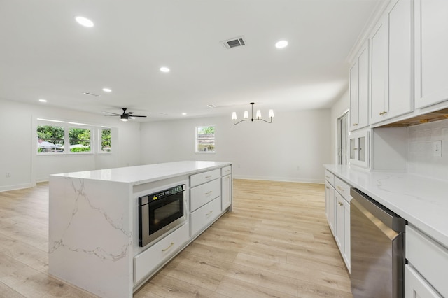 20 NW Higdon Ct, Fort Walton Beach, FL 32547 - kitchen featuring appliances with stainless steel finishes, recessed lighting, light wood finished floors, baseboards, and a chandelier