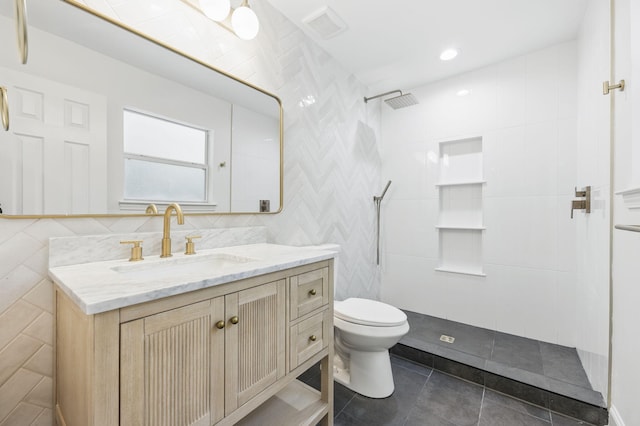 20 NW Higdon Ct, Fort Walton Beach, FL 32547 - full bathroom with toilet, vanity, tiled shower, tile patterned floors, and tile walls