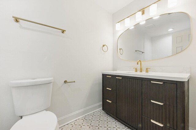 20 NW Higdon Ct, Fort Walton Beach, FL 32547 - bathroom with toilet, baseboards, vanity, and tile patterned floors