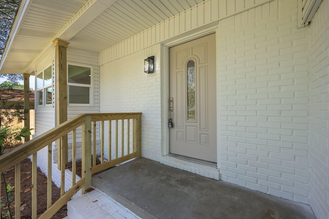 20 NW Higdon Ct, Fort Walton Beach, FL 32547 - doorway to property featuring brick siding and a porch