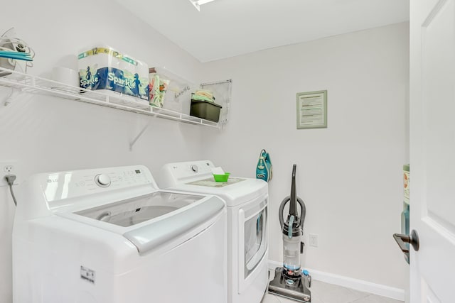 2076 Scenic Gulf Dr Unit 4011, Miramar Beach, FL 32550 - laundry area with washer and clothes dryer, light tile patterned floors, and baseboards