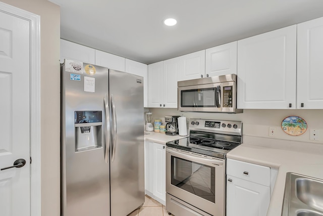 2076 Scenic Gulf Dr Unit 4011, Miramar Beach, FL 32550 - kitchen with appliances with stainless steel finishes, light countertops, white cabinetry, light tile patterned floors, and recessed lighting