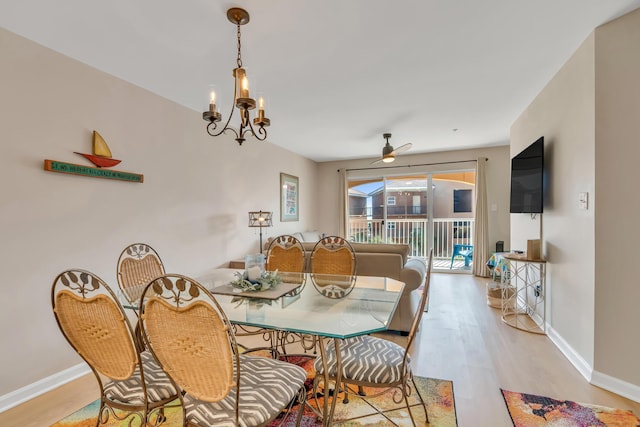 2076 Scenic Gulf Dr Unit 4011, Miramar Beach, FL 32550 - dining area featuring wood finished floors, a ceiling fan, baseboards, and a chandelier