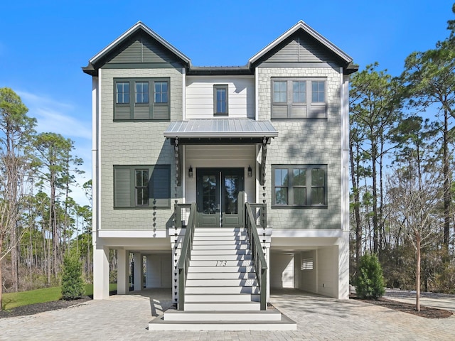 173 Crissman Rd, Santa Rosa Beach, FL 32459 - coastal home featuring a carport, decorative driveway, stairs, and metal roof