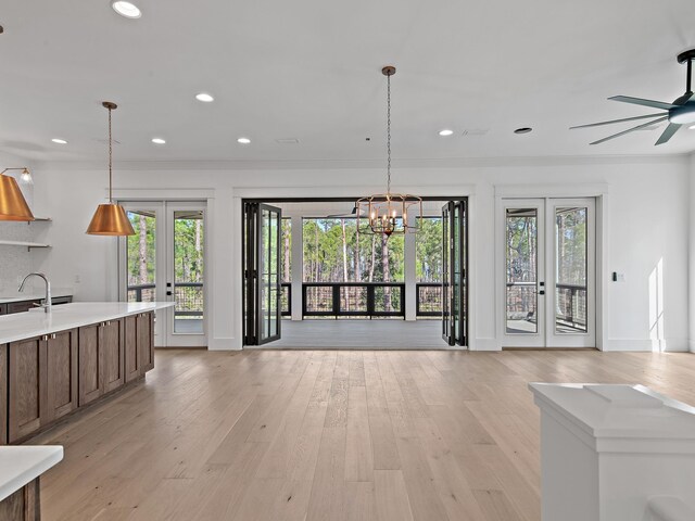173 Crissman Rd, Santa Rosa Beach, FL 32459 - unfurnished living room with french doors, a chandelier, healthy amount of natural light, recessed lighting, and light wood-type flooring