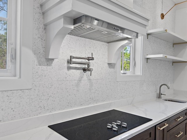173 Crissman Rd, Santa Rosa Beach, FL 32459 - kitchen with a sink, black electric stovetop, dark brown cabinets, open shelves, and light stone counters