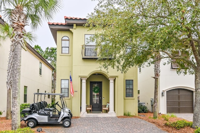 1843 Boardwalk Dr, Sandestin, FL 32550 - view of front of home with stucco siding, a garage, a tiled roof, and driveway