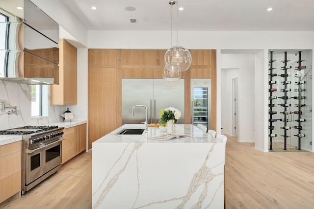 238 Sand Oaks Cir, Santa Rosa Beach, FL 32459 - kitchen featuring modern cabinets, premium appliances, a sink, light brown cabinetry, and light wood-type flooring