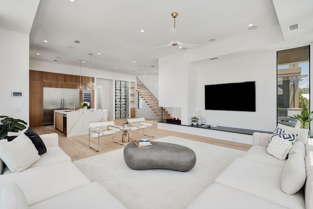 238 Sand Oaks Cir, Santa Rosa Beach, FL 32459 - living room with light wood finished floors, stairway, ceiling fan, and recessed lighting