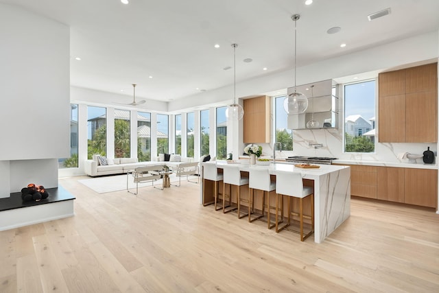 238 Sand Oaks Cir, Santa Rosa Beach, FL 32459 - kitchen featuring modern cabinets, an island with sink, light wood finished floors, healthy amount of natural light, and recessed lighting