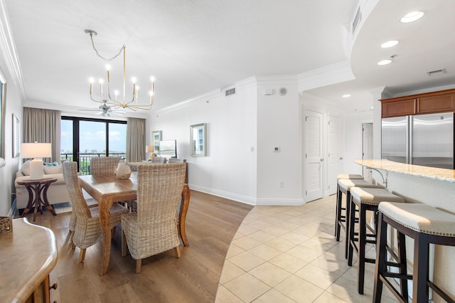 10 Harbor Blvd Unit E409, Destin, FL 32541 - dining space with a chandelier, crown molding, baseboards, recessed lighting, and light wood-style floors