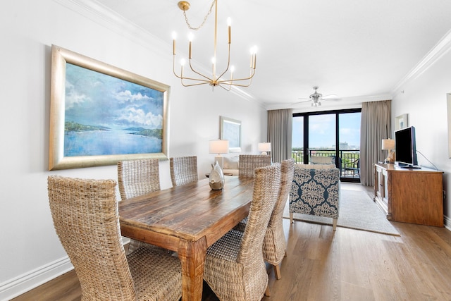 10 Harbor Blvd Unit E409, Destin, FL 32541 - dining area with a chandelier, wood finished floors, ornamental molding, ceiling fan, and baseboards