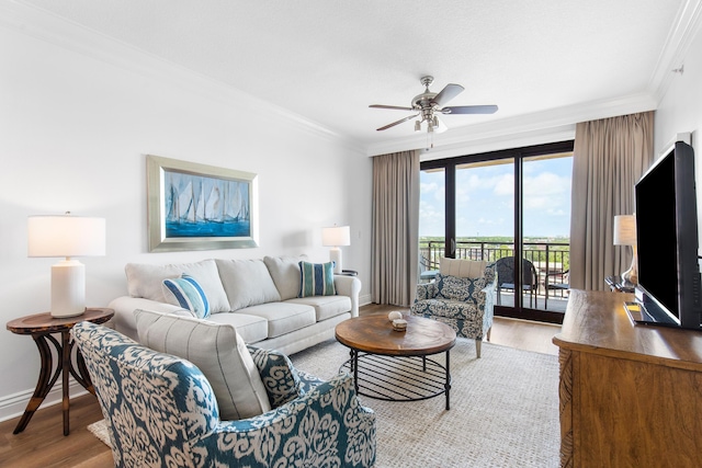 10 Harbor Blvd Unit E409, Destin, FL 32541 - living room featuring ornamental molding, baseboards, ceiling fan, and wood finished floors