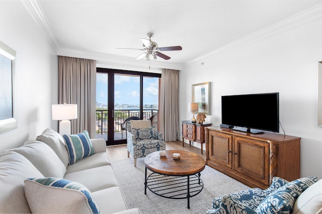 10 Harbor Blvd Unit E409, Destin, FL 32541 - living room with crown molding, ceiling fan, and light wood-style floors