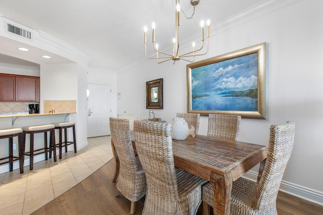 10 Harbor Blvd Unit E409, Destin, FL 32541 - dining space featuring a chandelier, ornamental molding, baseboards, light wood finished floors, and recessed lighting