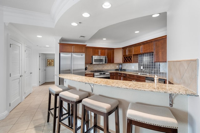 10 Harbor Blvd Unit E409, Destin, FL 32541 - kitchen featuring stainless steel appliances, light stone countertops, backsplash, ornamental molding, and a peninsula