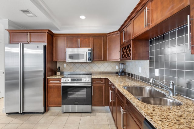 10 Harbor Blvd Unit E409, Destin, FL 32541 - kitchen with appliances with stainless steel finishes, a sink, light tile patterned floors, tasteful backsplash, and light stone counters