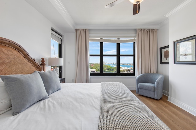 10 Harbor Blvd Unit E409, Destin, FL 32541 - bedroom with wood finished floors, multiple windows, ornamental molding, baseboards, and a ceiling fan