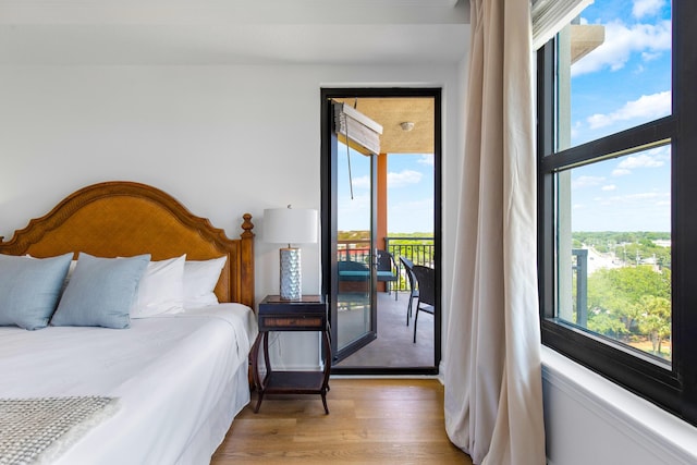 10 Harbor Blvd Unit E409, Destin, FL 32541 - bedroom featuring light wood-type flooring, access to outside, and multiple windows