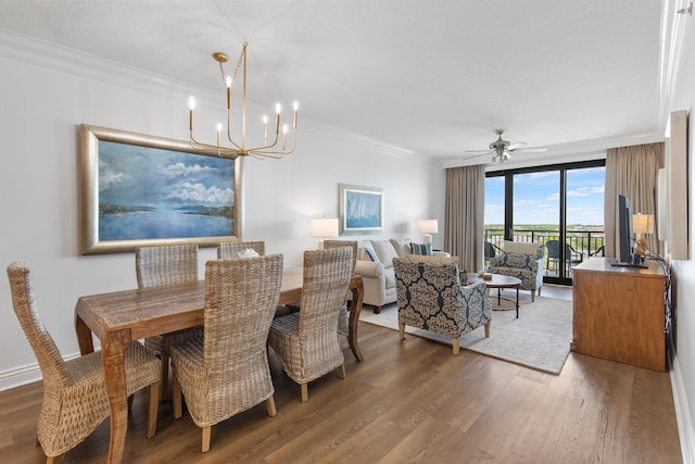 10 Harbor Blvd Unit E409, Destin, FL 32541 - dining space featuring wood finished floors, ornamental molding, a chandelier, and a ceiling fan