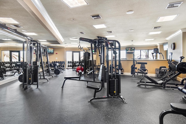10 Harbor Blvd Unit E409, Destin, FL 32541 - workout area with a textured ceiling, baseboards, and crown molding