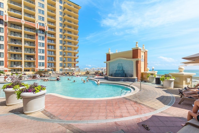 10 Harbor Blvd Unit E409, Destin, FL 32541 - community pool featuring an outdoor fireplace and a patio