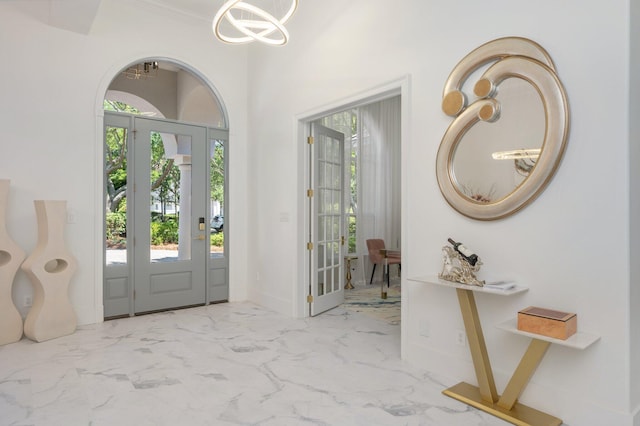 6290 Augusta Cv, Destin, FL 32541 - entryway with marble finish flooring, baseboards, a chandelier, and crown molding