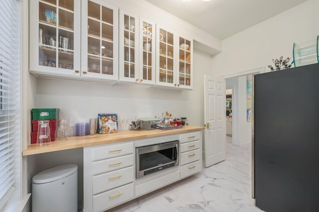 6290 Augusta Cv, Destin, FL 32541 - bar area with appliances with stainless steel finishes and light marble finish flooring