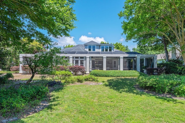 6290 Augusta Cv, Destin, FL 32541 - back of property featuring a yard and glass enclosure