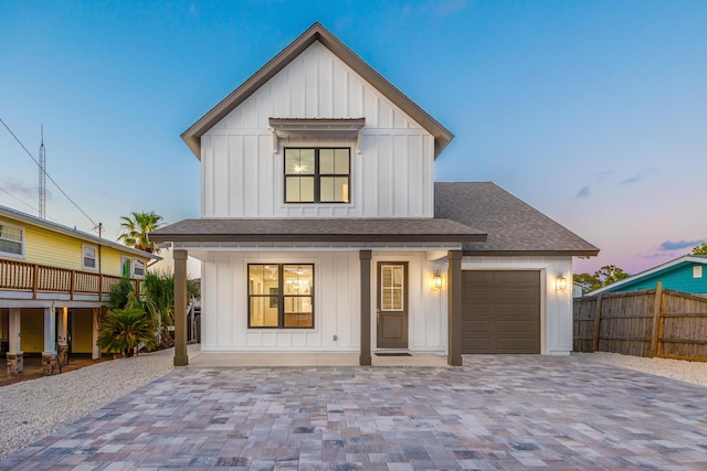 6424 Sunset Ave, Panama City Beach, FL 32408 - modern farmhouse featuring board and batten siding, a shingled roof, fence, an attached garage, and decorative driveway