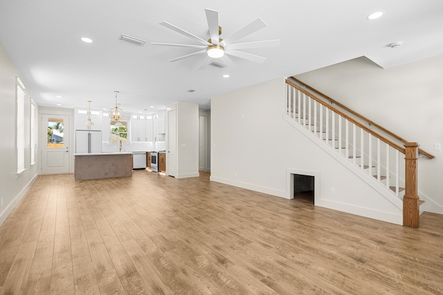 6424 Sunset Ave, Panama City Beach, FL 32408 - unfurnished living room with stairway, light wood finished floors, recessed lighting, ceiling fan, and baseboards