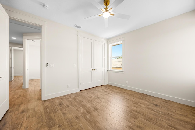 6424 Sunset Ave, Panama City Beach, FL 32408 - unfurnished bedroom featuring wood-type flooring, baseboards, a closet, and a ceiling fan