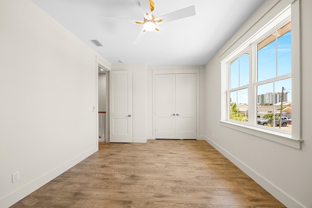 6424 Sunset Ave, Panama City Beach, FL 32408 - unfurnished bedroom featuring wood finished floors, baseboards, a closet, and ceiling fan