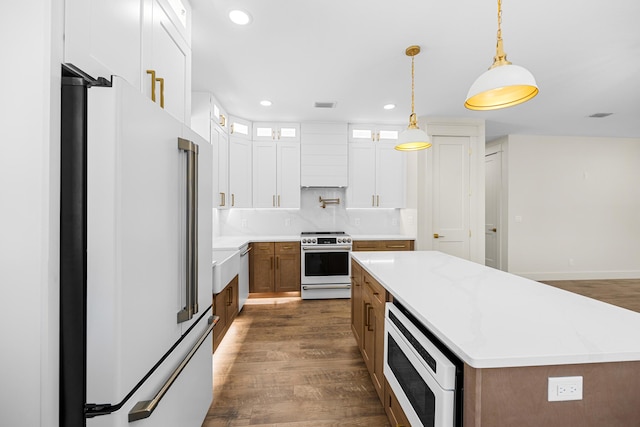 6424 Sunset Ave, Panama City Beach, FL 32408 - kitchen with freestanding refrigerator, range with electric cooktop, built in microwave, dark wood-style floors, and recessed lighting
