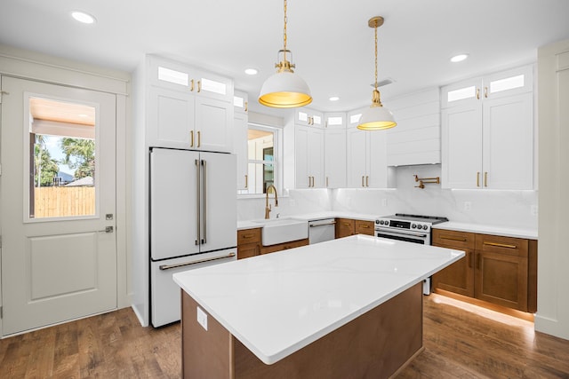 6424 Sunset Ave, Panama City Beach, FL 32408 - kitchen featuring stainless steel appliances, a sink, glass insert cabinets, dark wood finished floors, and recessed lighting